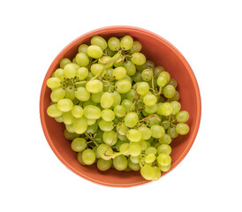 Bunch of ripe seedless grapes in a ceramic dish on a white background, macro, top view.