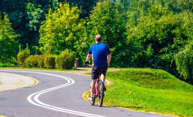 Fototapeta premium Cyclist ride on the bike path in the city Park 