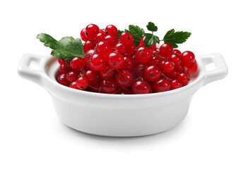 Ripe red currants with green leaves in bowl isolated on white