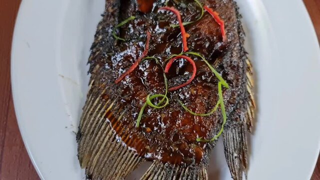 Gurame Bakar Madu or honey grilled gurami is very delicious Indonesian specialty combined with shrimp paste chili sauce and warm rice. The savory and sweet taste of honey makes it even more delicious 