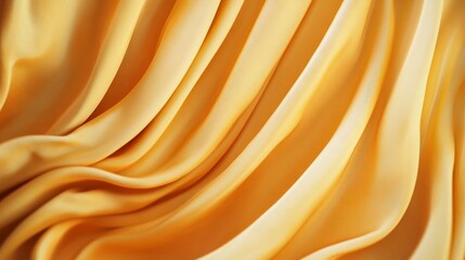 Obraz premium A close-up shot of golden fabric draped with soft, smooth, flowing folds, showcasing a luxurious and elegant texture. The fabric's deep yellow hue creates a warm and inviting feel, symbolizing luxury,