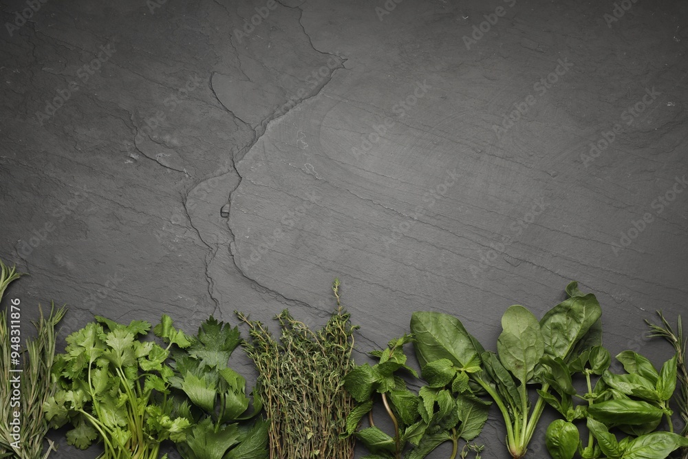 Sticker Different fresh herbs on grey textured table, flat lay. Space for text