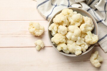 Tasty cooked cauliflower on white wooden table, top view. Space for text