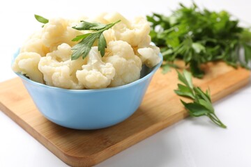 Tasty cauliflower with parsley on white table, closeup