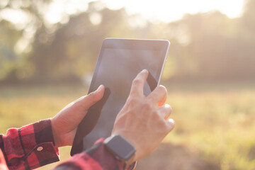Farmers are using tablets to record data on their farm. Solar farm, smart farm, data collection