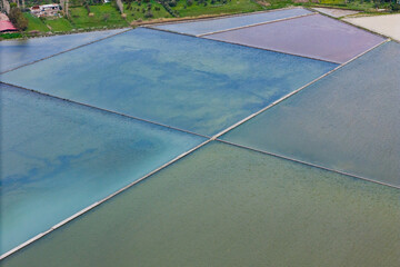 Evaporation salt ponds on saltworks, Aerial view of Salt fields. Sea Salt Works
