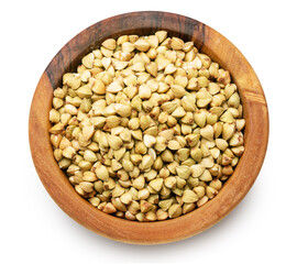 Wooden bowl of raw buckwheat on white background. File contains clipping path. Top view.
