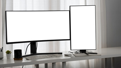 A clean and minimalistic dual-monitor setup on a sleek desk, featuring a wide monitor and a vertical screen, perfect for multitasking and productivity