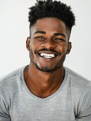 Obraz premium Authentic Portrait: Smiling Young African American Man in Grey T-shirt, Studio Photoshoot