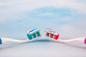 Toothbrush and toothpaste, squeezing toothpaste from tube onto toothbrush close-up. Daily oral care after meals concept.