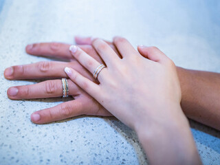 Gwangju, Jeollanam-do, South Korea - August 14, 2021: Bride and groom are holding hands with wedding rings at wedding hall