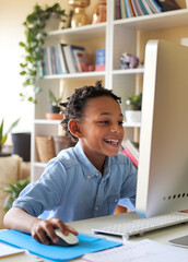 Child homeschooling in front of computer at a desk