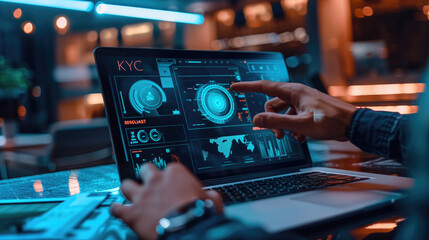 Person using a laptop with futuristic digital interface screens displaying KYC and data visualization in a modern office.