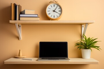 A modern workspace with a laptop, clock, books, and plant on a wooden shelf against an orange wall