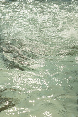 Shimmering water with sunlight reflections. Water background