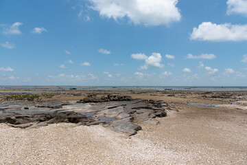 The landscape of coastal reefs after low tide and the fishing grounds in the distance