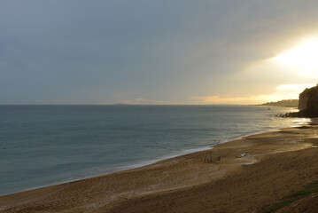 High angle and sunset view of Jungmun Saekdal Beach with footprints on sand near Seogwipo-si, Jeju-do, South Korea