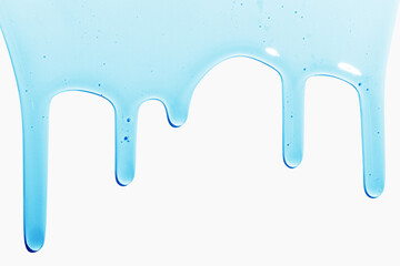 Flowing transparent blue liquid on a light background. Cosmetics, shampoo, serum, snail slime.
