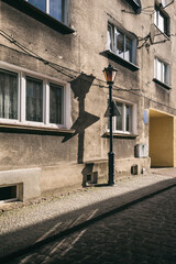 A STREET IN THE CITY - Stylish street lamp and old tenement houses in the background  © Wojciech Wrzesień