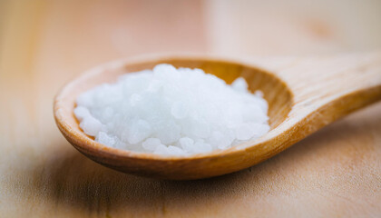 Wooden spoon with salt on table. Cooking concept.