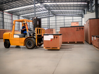 Project cargo in big wooden boxes stored in the warehouse. The cargo in wooden boxes handling by forklift.