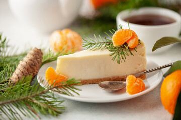 Tangerine cheesecake on a plate in Christmas decor
