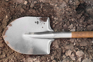 Metal shovel on soil outdoors, top view