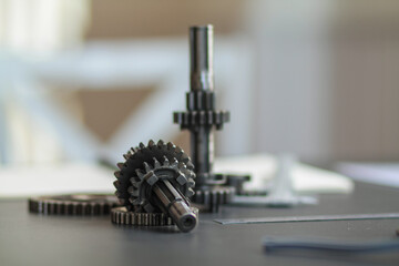 The gear set is placed on the workbench of a team of factory mechanical engineers to study and design the working system of the mechanical gearbox in the factory to complete the production.