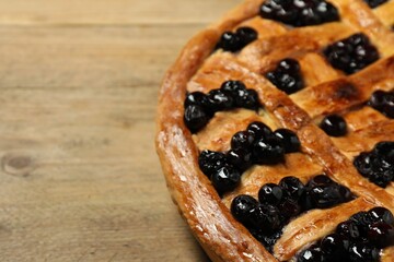 Tasty homemade pie with blueberries on wooden table, closeup. Space for text