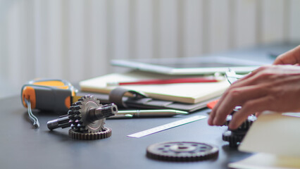 The gear set is placed on the workbench of a team of factory mechanical engineers to study and design the working system of the mechanical gearbox in the factory to complete the production.