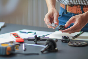 The gear set is placed on the workbench of a team of factory mechanical engineers to study and design the working system of the mechanical gearbox in the factory to complete the production.