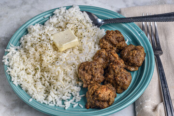 rice  top with parsley and pepper  with meatballs