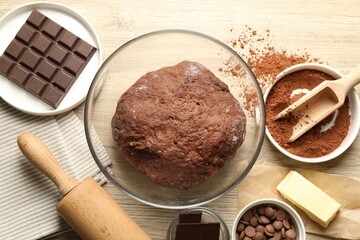 Chocolate dough and ingredients on wooden table, flat lay