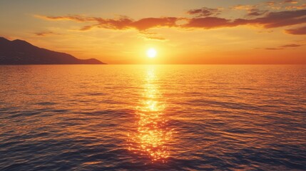 Obraz premium Serene Golden Sunset on Calm Sea with Warm Glow - Idyllic Clear Weather Scene for Relaxation and Reflection