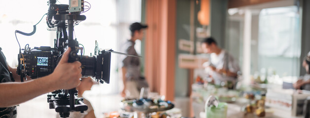 Professional film and video camera on the set. Shooting shift, equipment and group.