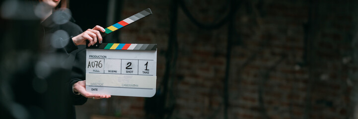 Assistant director with clapperboard on set. Close-up of firecrackers for filming a movie