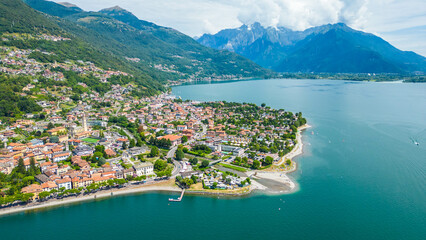Obraz premium An aerial view of Domaso, a beautiful village nestled on the shores of Lake Como, Italy, captured by a drone. This charming destination is known for its picturesque lakeside scenery, quaint streets
