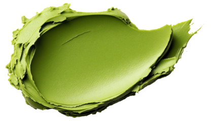 Close-up of a smudge of green creamy substance on a white background, possibly cosmetic cream or natural paste.