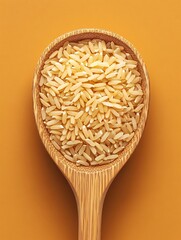 Close-up of brown rice in a wooden spoon against a black background.