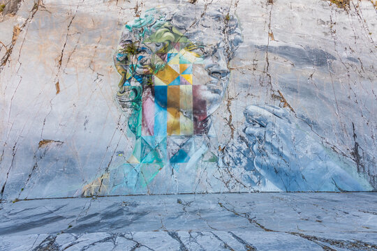The famous David murales by Kobra, inspired by Michelangelo. Street art on white marble.