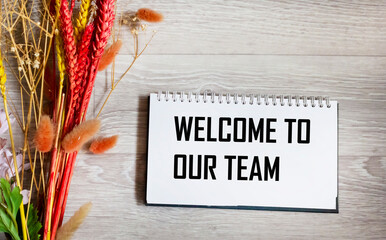 Naklejka premium Welcome to our team symbol. Conceptual words Welcome to our team on a notepad Beautiful background.