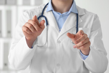 Doctor pointing at something in clinic, closeup