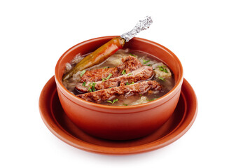 Steaming hot bowl of soup with meat and vegetables