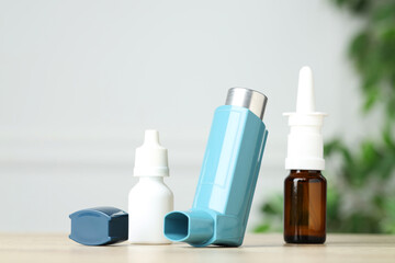 Different asthma medications on wooden table, closeup