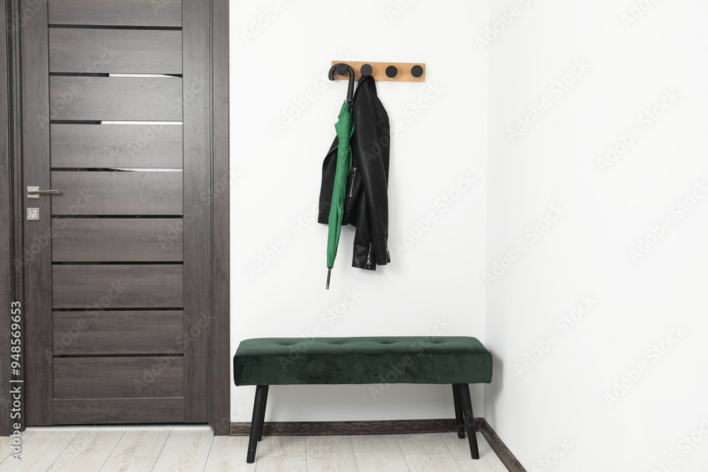 Wall mural green umbrella, leather jacket, rack and ottoman in hallway