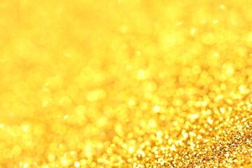 Beautiful shiny golden glitter as background, closeup