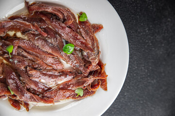 anchovies in a plate on the table canned fish in oil fresh and tasty seafood meal food snack on the table copy space food background rustic