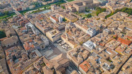 An aerial view of Parma, Italy, showcasing the iconic Cattedrale di Parma and the Battistero di Parma, captured by a drone.  This historic city is known for its rich cultural heritage