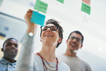 Brainstorming, glass and group in office, sticky notes and planning for presentation, publicist and...