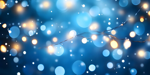 Glowing white bokeh lights on a blurry blue background. Christmas lights